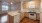 Spacious and well lit kitchen with wood flooring and stainless steel appliances