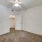 Large well lit bedroom with plush carpets and large windows 