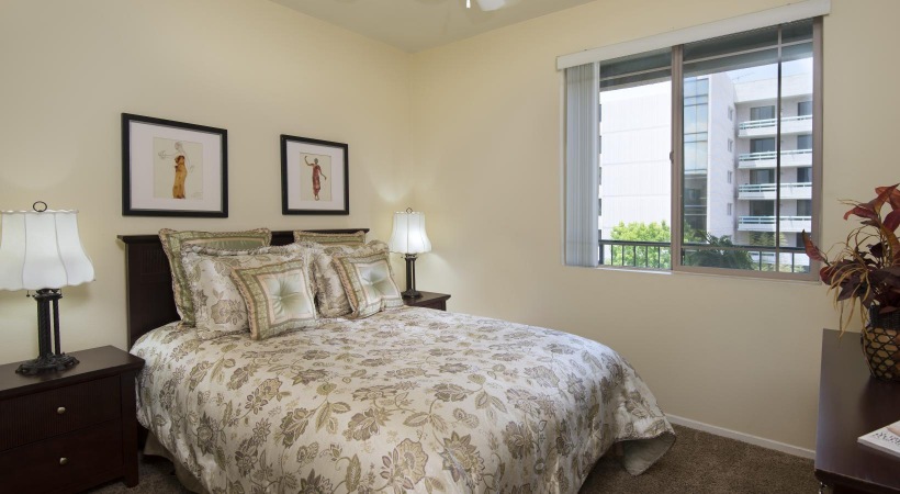 a bedroom with a bed and a window